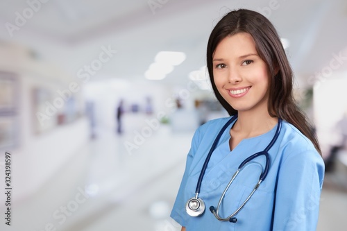 Beautiful young woman doctor smiling in work uniform
