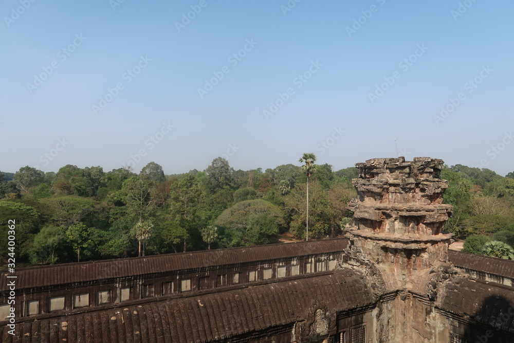 blue sky over old temple ruins of khmer city angkor wat, cambodia, beautiful tower, forest in the background