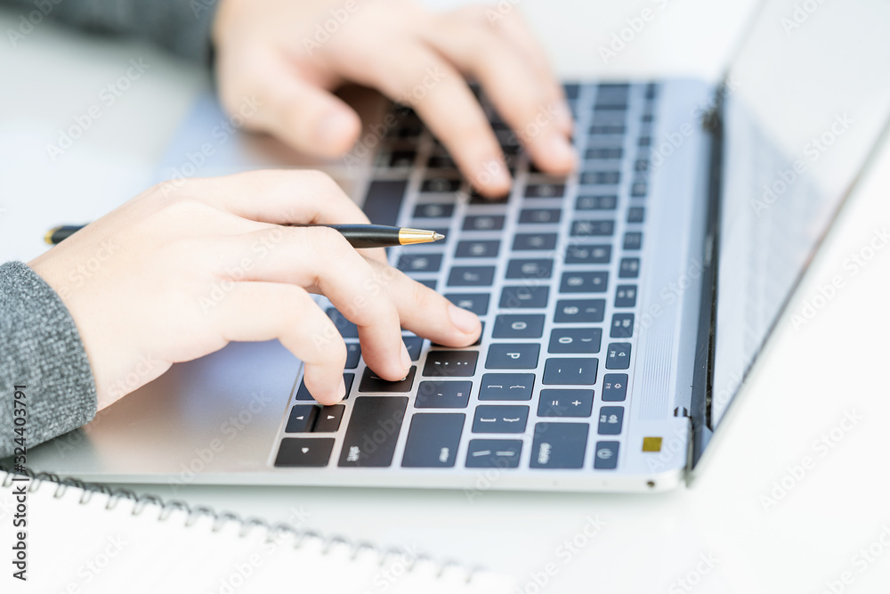 Woman working at home office using laptop searching web, browsing information Woman working at home office using laptop searching web, browsing information