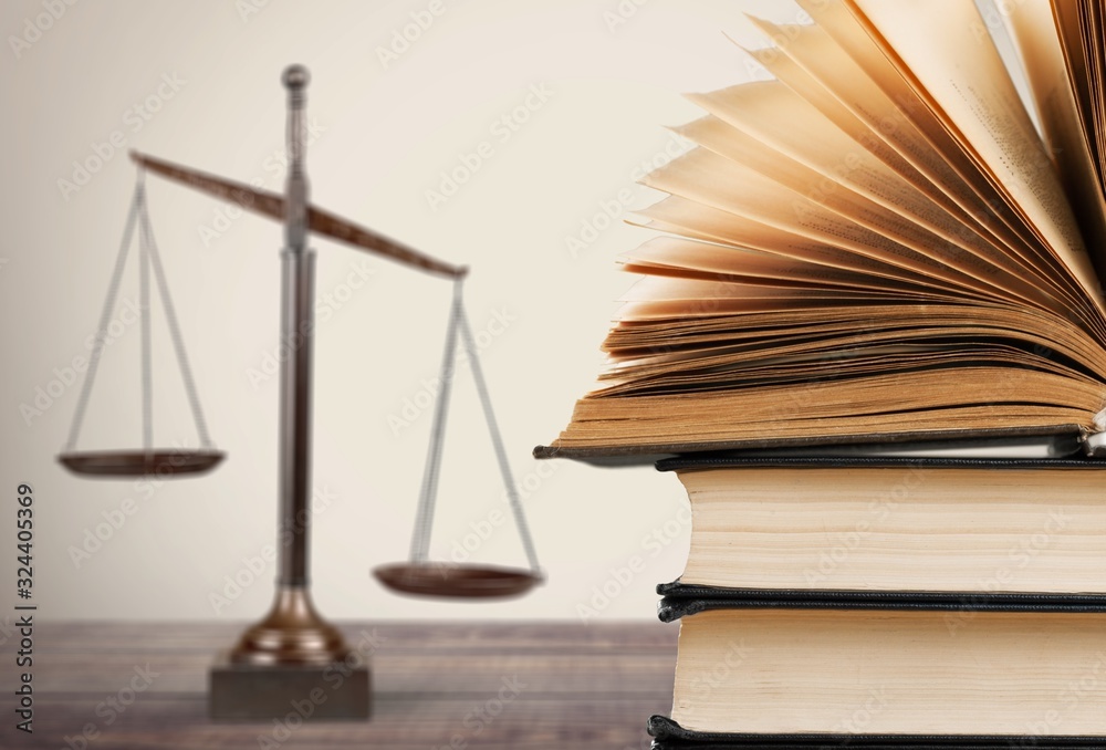 Law scales and books on wooden table. Symbol of justice Law scales and books on wooden table. Symbol of justice