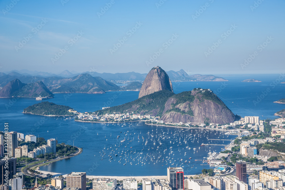 View from Mirante Dona Marta of Guanabara Bay & sugarloaf mountain on a clear day with blue sky and mountains in the background and Atlantic Ocean in Rio de Janeiro, Brazil, South America