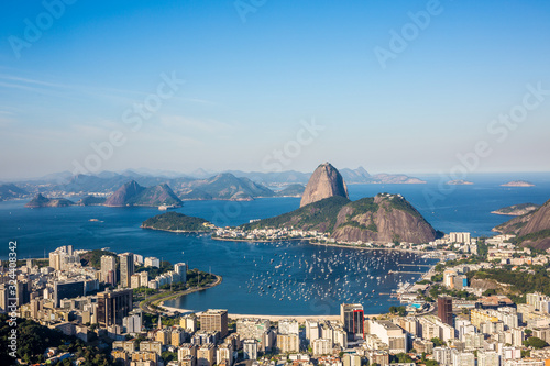 View from Mirante Dona Marta of Guanabara Bay & sugarloaf mountain on a clear day with blue sky and mountains in the background and Atlantic Ocean in Rio de Janeiro, Brazil, South America