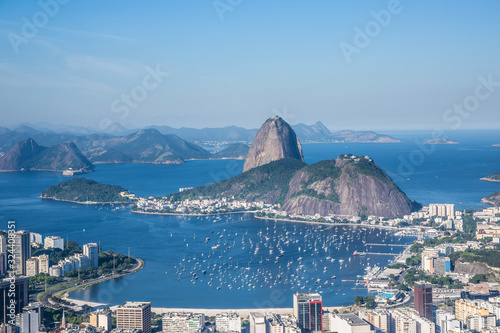 View from Mirante Dona Marta of Guanabara Bay & sugarloaf mountain on a clear day with blue sky and mountains in the background and Atlantic Ocean in Rio de Janeiro, Brazil, South America