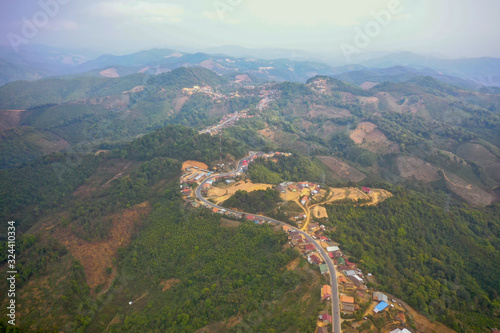 aerial scenic view of mountain road and rural village living along  in Laos. 