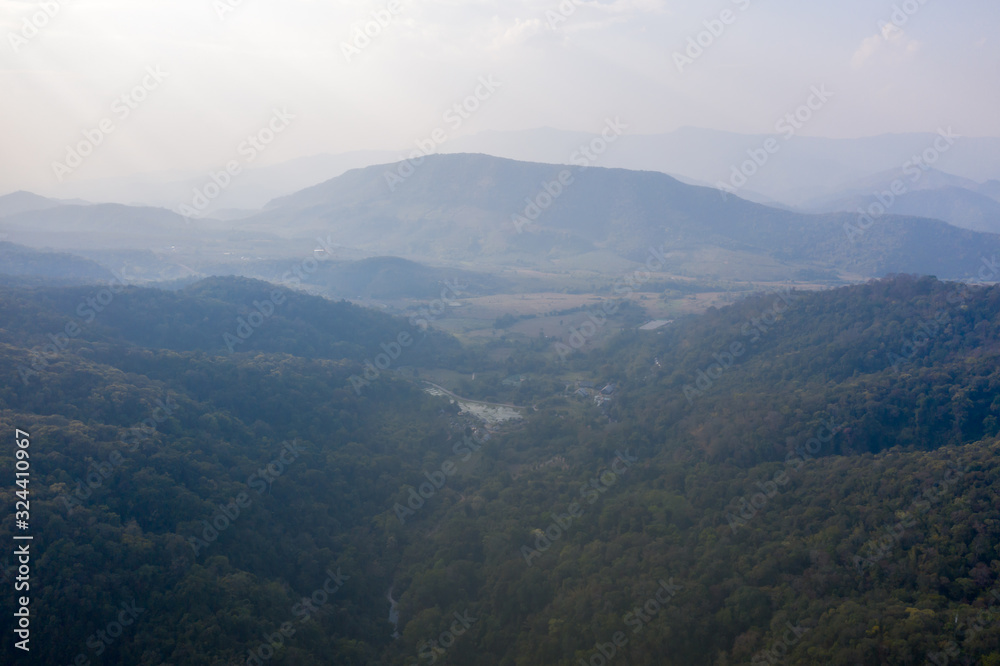 High angle scenic view of mountain against foggy sky 