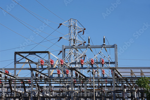 Sectional view of the equipment of an electricity substation and a distribution tower with power lines