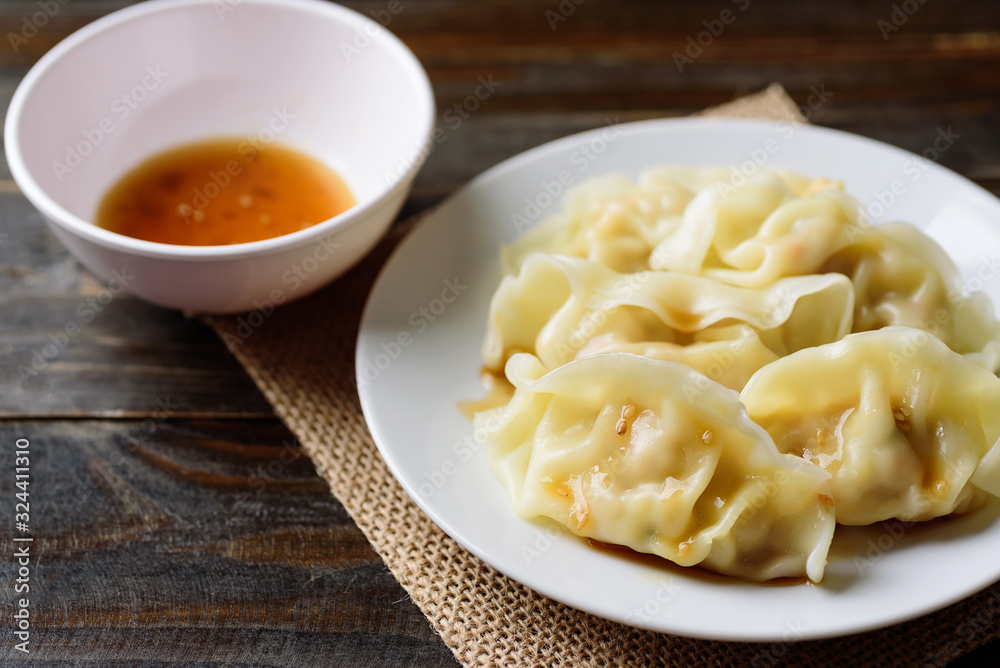 Steamed wonton dumpling stuffed with minced pork and shrimp eating with sesame oil sauce Steamed wonton dumpling stuffed with minced pork and shrimp eating with sesame oil sauce