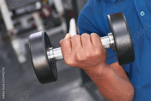 Close up of man hand with dumbbell exercise.