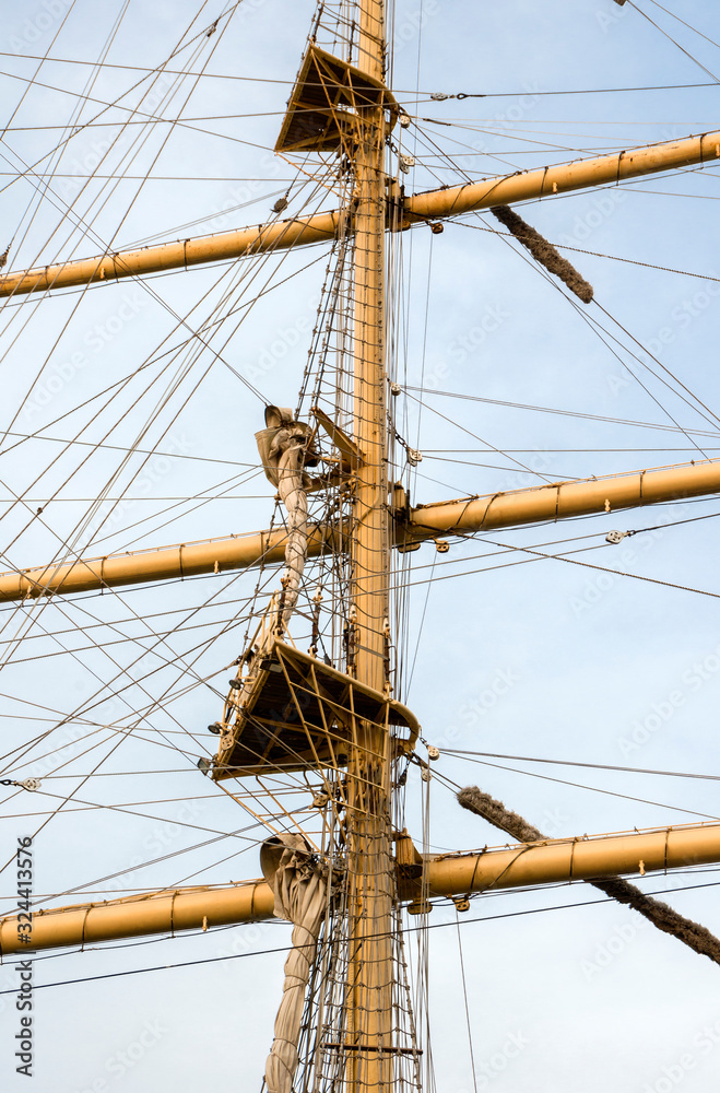 Mast sailing ship against a blue sky Mast sailing ship against a blue sky