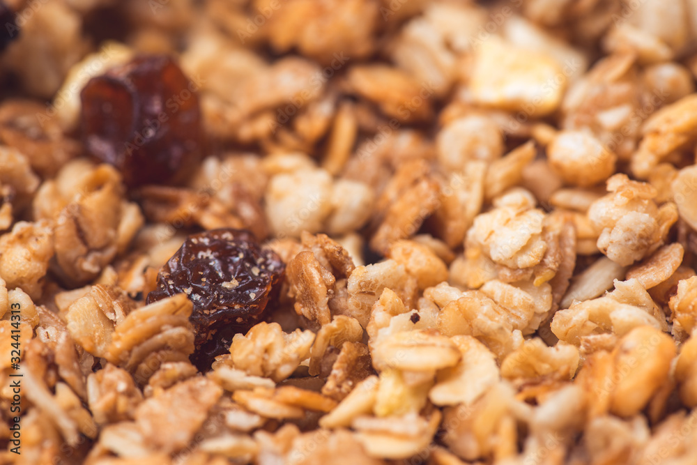 Useful and tasty muesli with nuts, rasins and flakes. Selective focus macro shot with very shallow depth of field. Healthy and vegetarian lifestyle Useful and tasty muesli with nuts, rasins and flakes. Selective focus macro shot with very shallow depth of field. Healthy and vegetarian lifestyle