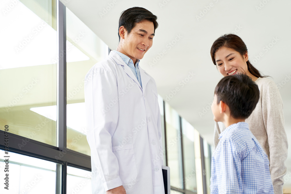 young asian doctor talking to mother and son in hospital young asian doctor talking to mother and son in hospital