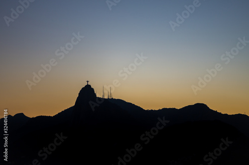 View of Christ the redeemer (Cristo Redentor) as a silhouette on top of Mount Corcovado just after sunset as nightfall begins in Rio de Janeiro, Brazil, South America