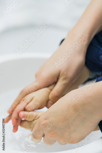 Asian mothers washing hands for infants © Allen Chen