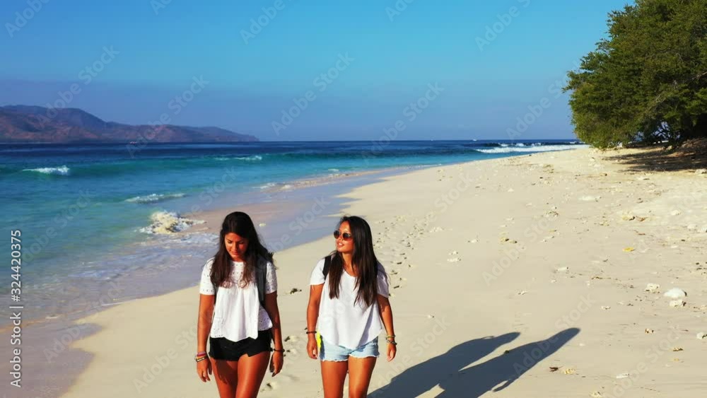 beautiful young women in the white t-shirts walking barefoot on the ...