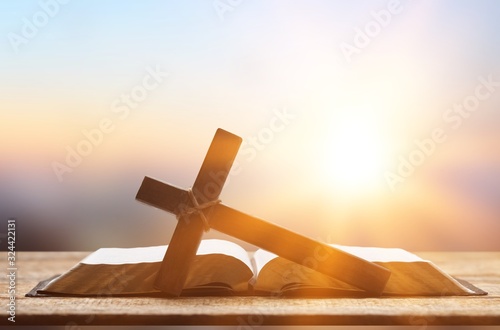 Fotografie Holy Bible book and cross on a wooden desk