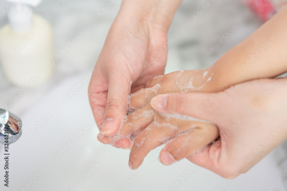 Young asian woman washing hands for her son Young asian woman washing hands for her son