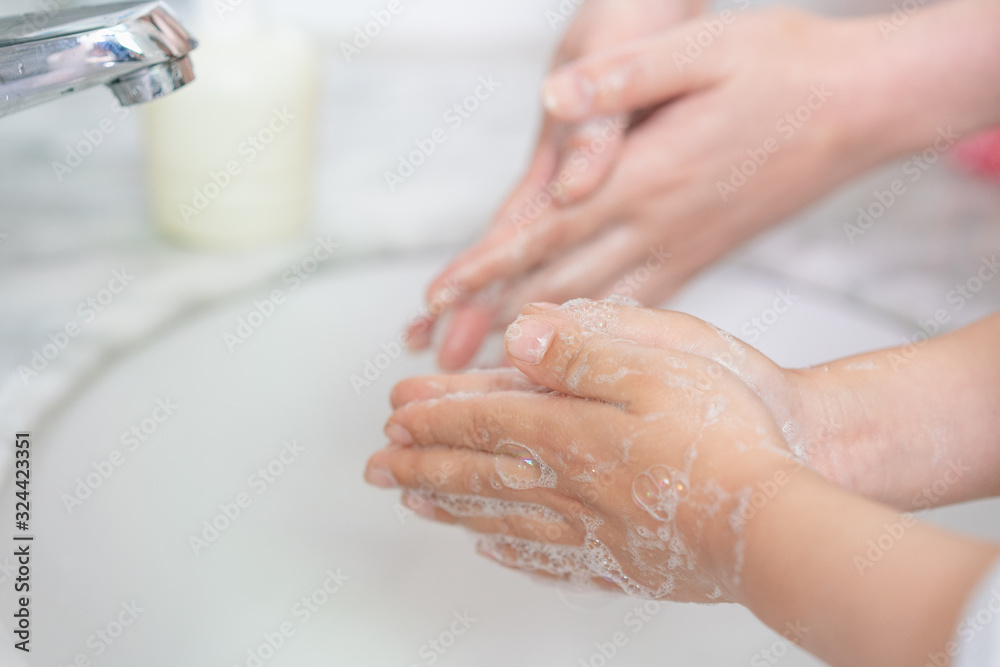 Young asian woman washing hands for her son