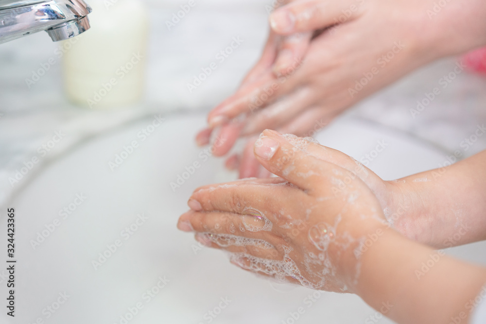 Young asian woman washing hands for her son Young asian woman washing hands for her son