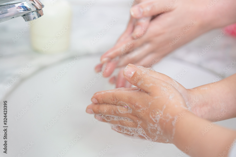 Young asian woman washing hands for her son Young asian woman washing hands for her son