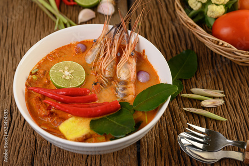 Tom Yum Kung Thai hot spicy soup shrimp with lemon grass lemon galangal and chilli on wooden background Thailand Food