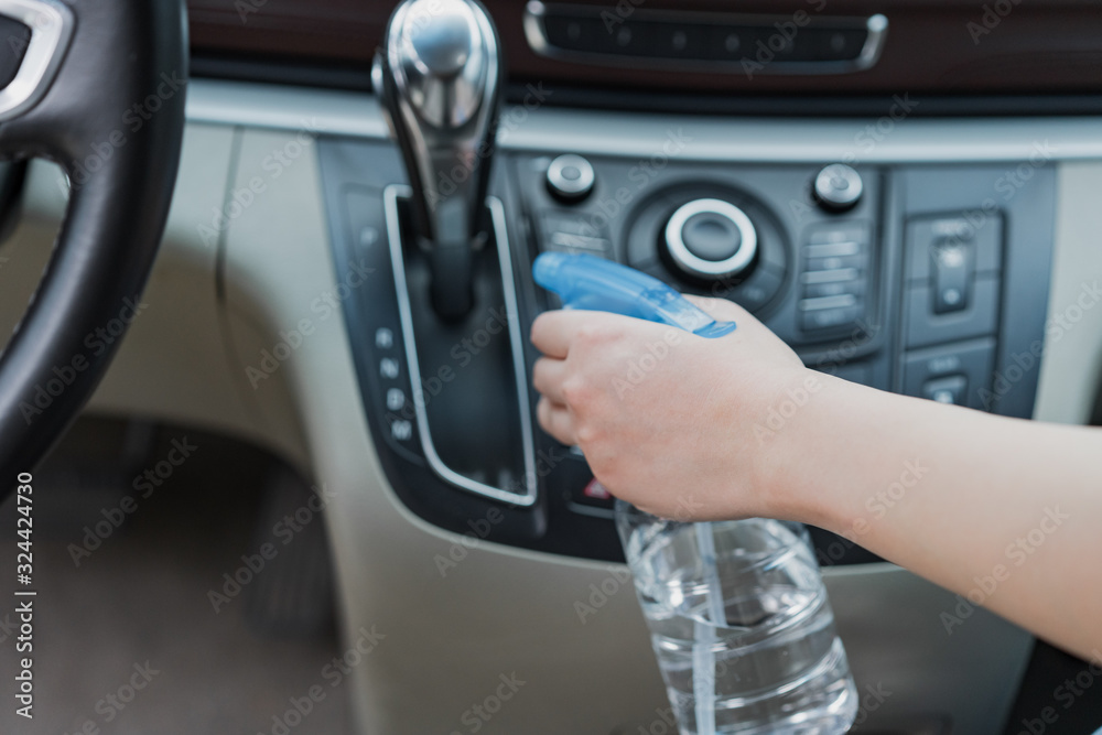 Asian women disinfect and clean car interior