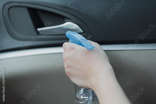 Asian women disinfect and clean car interior