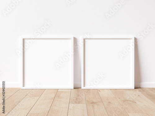 Two square white frame mock up on wooden floor with white wall. 3D illustrations.