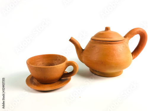 Brown clay teapot and teacup, isolated on white background