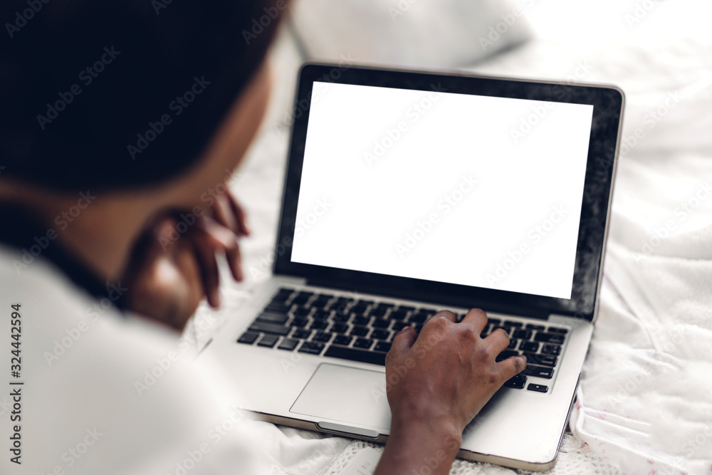 Young african american black woman relaxing and using laptop computer with white mockup blank screens.woman checking social apps and working.Communication and technology concept Young african american black woman relaxing and using laptop computer with white mockup blank screens.woman checking social apps and working.Communication and technology concept