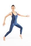 Adult woman dancer in blue bodysuit dancing in the studio.