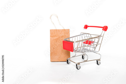 New shopping cart with brown paper shopping bag isolate on white background, business object concept, buy and sale online shopping