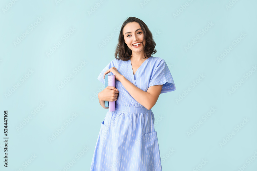 Beautiful young woman with books on color background Beautiful young woman with books on color background