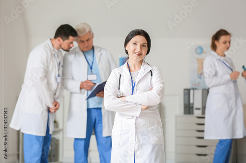 Female doctor with colleagues in clinic