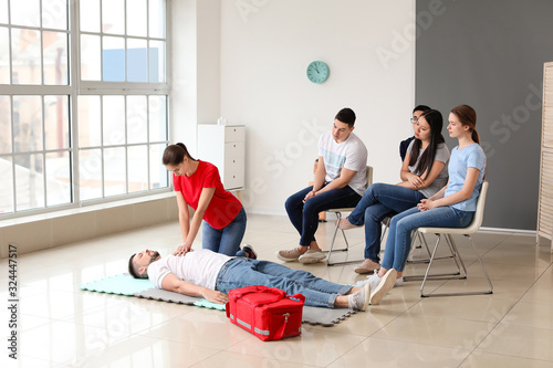 Obraz na płótnie Instructor demonstrating CPR on man at first aid training course