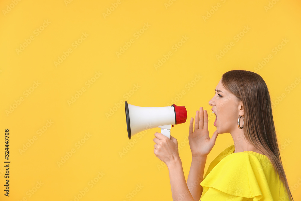 Young woman with megaphone on color background Young woman with megaphone on color background