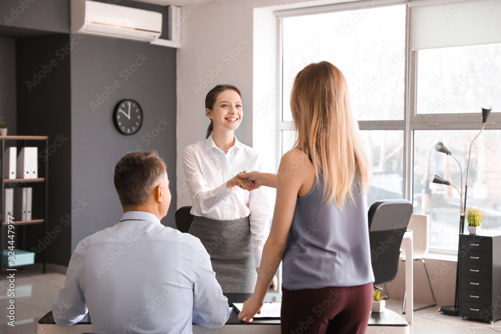 Fototapeta premium Human resources manager shaking hands with applicant after successful interview