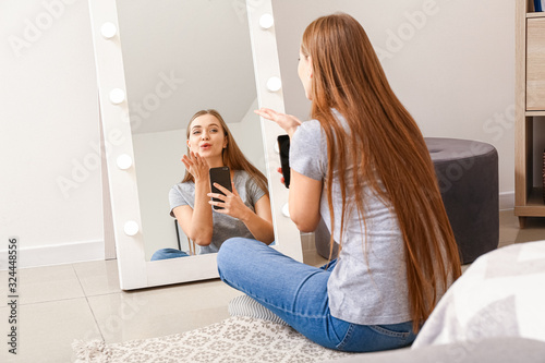 Beautiful young woman takin...