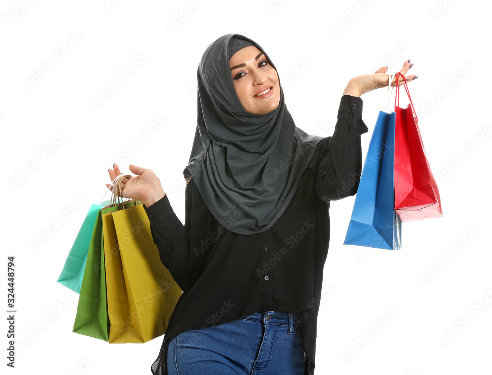 Young Arab woman with shopping bags on white background Young Arab woman with shopping bags on white background