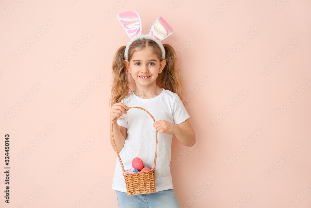 Little girl with Easter eggs and bunny ears on color background Little girl with Easter eggs and bunny ears on color background