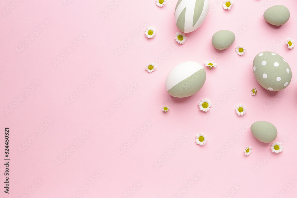 Beautiful Easter eggs and flowers on color background
