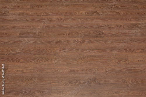 Natural dark brown wooden surface floor texture background. polished laminate parquet