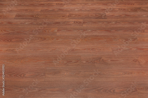 Natural dark brown wooden surface floor texture background. polished laminate parquet