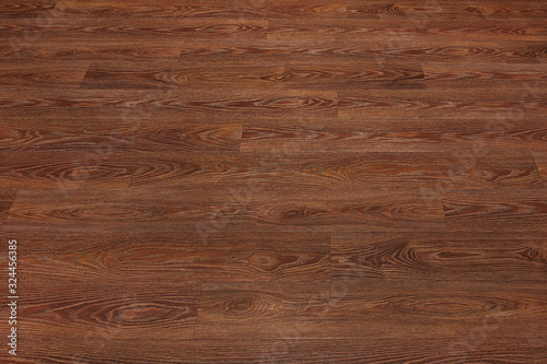 Natural dark brown wooden surface floor texture background. polished laminate parquet
