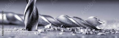 Fotografija Electric drill bit drills a hole in the board