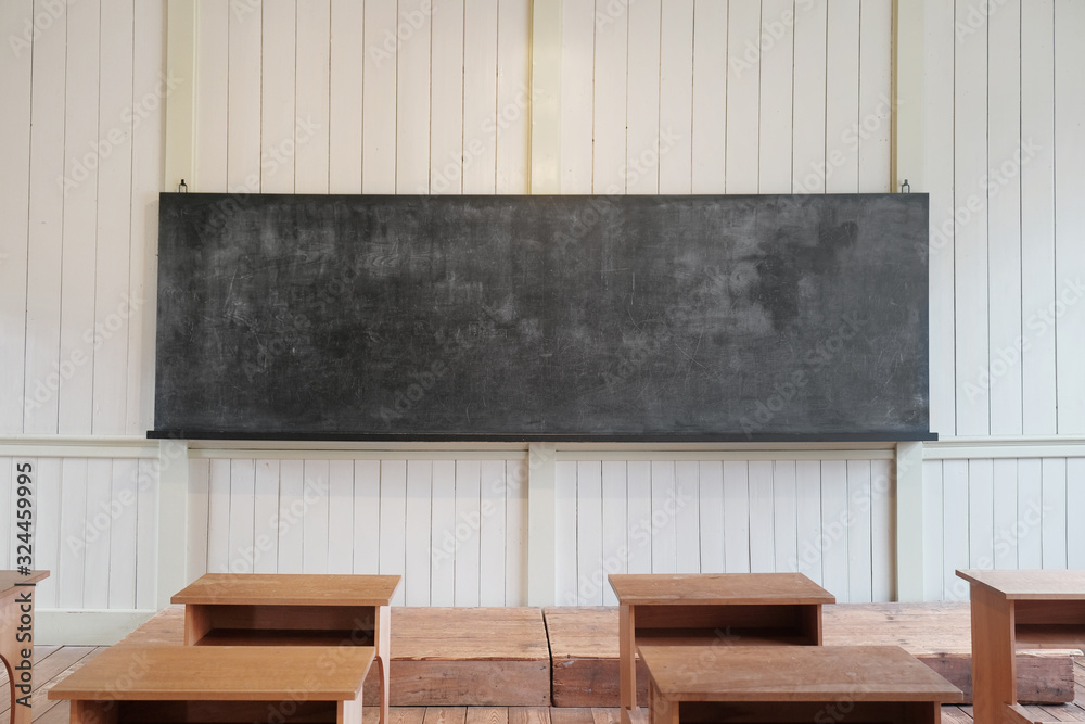 Old chalkboard in classic wooden classroom Old chalkboard in classic wooden classroom