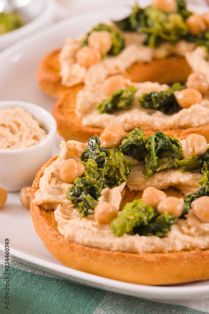 Friselle with turnip tops and hummus. Friselle with turnip tops and hummus.