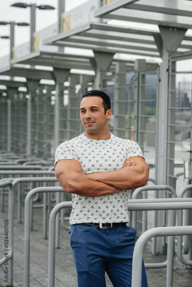 A sports guy stands and enjoys a walk near the stadium. Lifestyle A sports guy stands and enjoys a walk near the stadium. Lifestyle