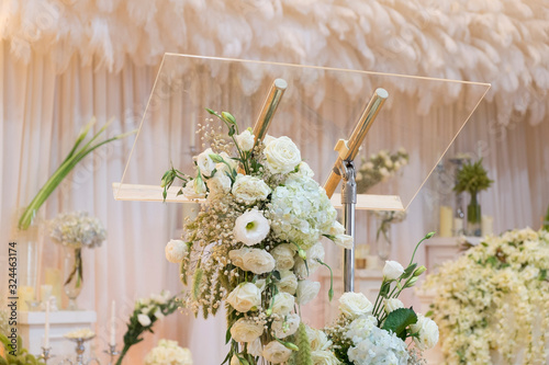 Flower decoration on transparent podium with backdrop and candles