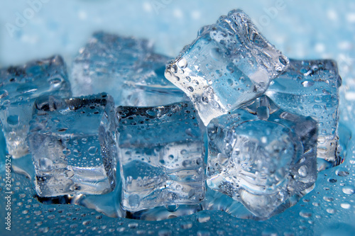 Ice cubes / Melting ice cubes on blue background, close up