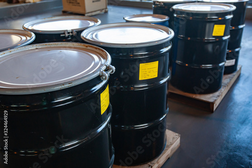 Group of steel drums storing hazardous waste in a sheltered accumulation area